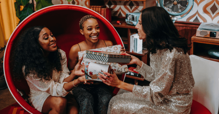 women exchanging holiday gifts