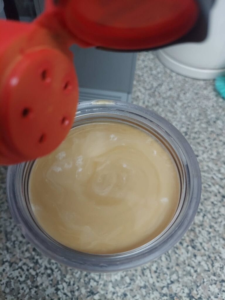 bottle with red cap and iced coffee